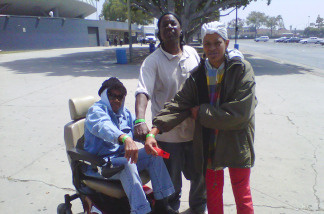 Cora Russell, left, and two companions show off the wristbands that allow them access to the Remote Area Medical event at the Los Angeles Memorial Sports Arena.
