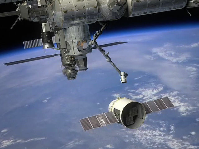 A NASA rendering of SpaceX's Dragon capsule as it prepares to berth with the International Space Station.