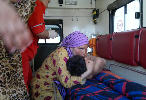 A woman embraces an injured Syrian boy i