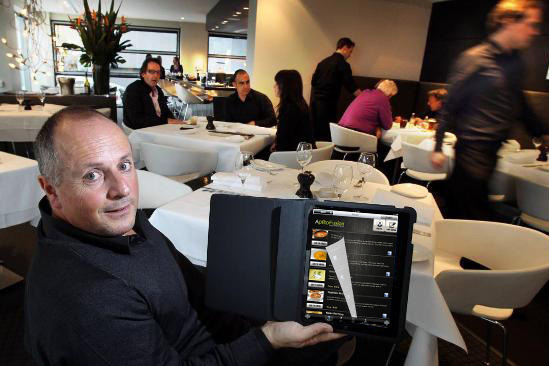 A restaurant customer tries out the Aptito app on a digital menu.