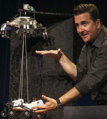 Adam Steltzner led the NASA team that dreamed up a new way to land on Mars. He's seen here at JPL on Aug. 2 using a scale model to explain how the rover Curiosity will land on the red planet.