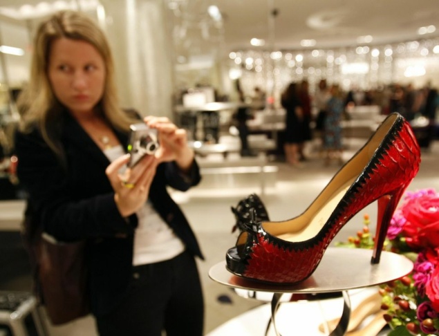 Customers look at a pair of Christian Lo