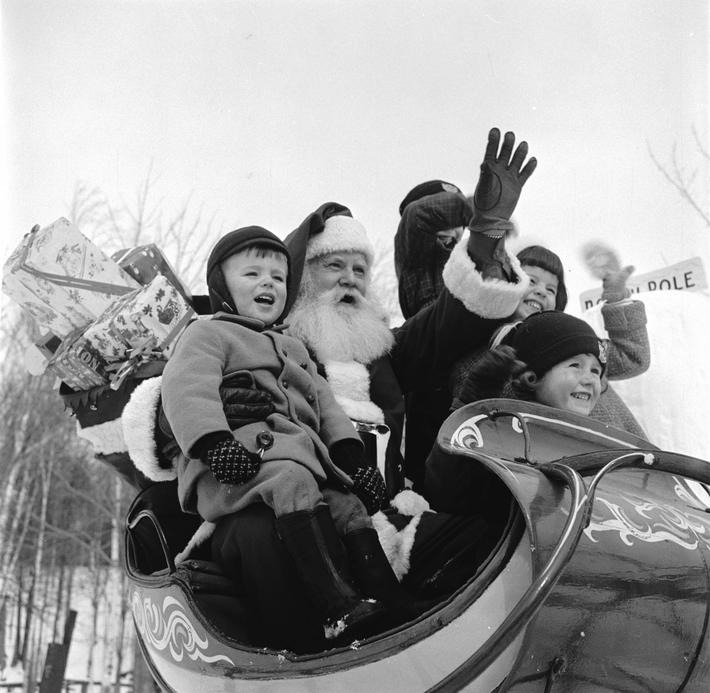 Santa Claus treats young visitors to a sleigh ride at his North Pole Workshop in the Adirondack Mountains of New York State.