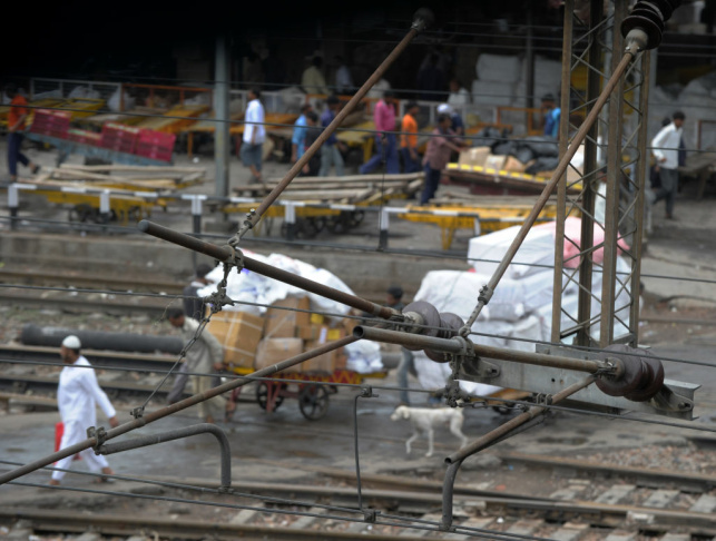 Porters at a train station in Delhi push