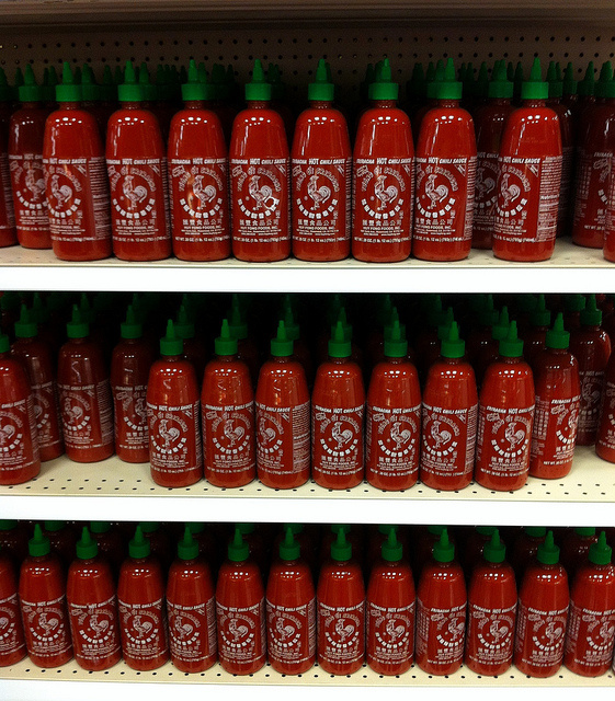 Bottles of Sriracha hot sauce in a supermarket.