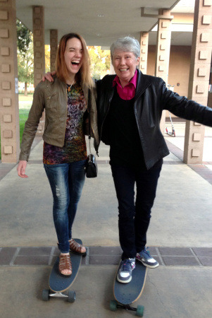 Harvey Mudd President Maria Klawe often uses her longboard to get around campus and chat with students like senior Xanda Schofield.
