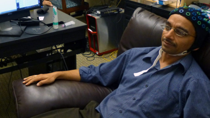 Acting as a "sender," brain researcher Rajesh Rao watches a video game and waits for the time to hit the "fire" button. But he'll only think about doing that — the impulse was carried out by someone in another building, in a recent test of brain-to-brain
