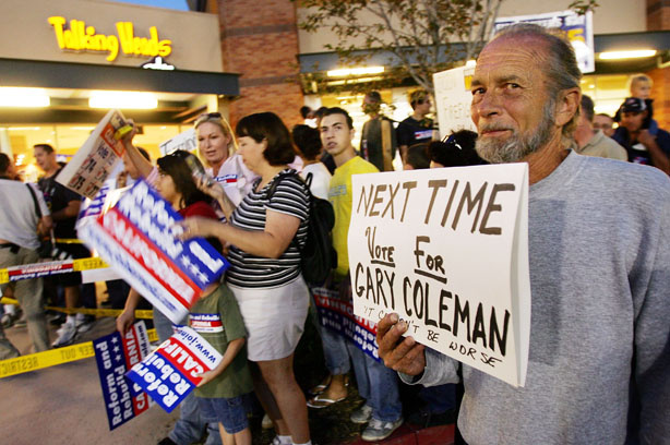 Art Cassel, who opposes California Governor Arnold Schwarzenegger's initiatives, displays a sign that says, 'next time vote for Gary Coleman,' during the governor's campaign stop at the Corona Republican Party Headquarters on the eve of his Special Election on November 7, 2005 in Corona, California. For nearly a century, voters in California have expressed their displeasure toward the government by means of the initiative and the recall. But some say that has only made it harder for elected officials to do their jobs and gain the voters' trust.