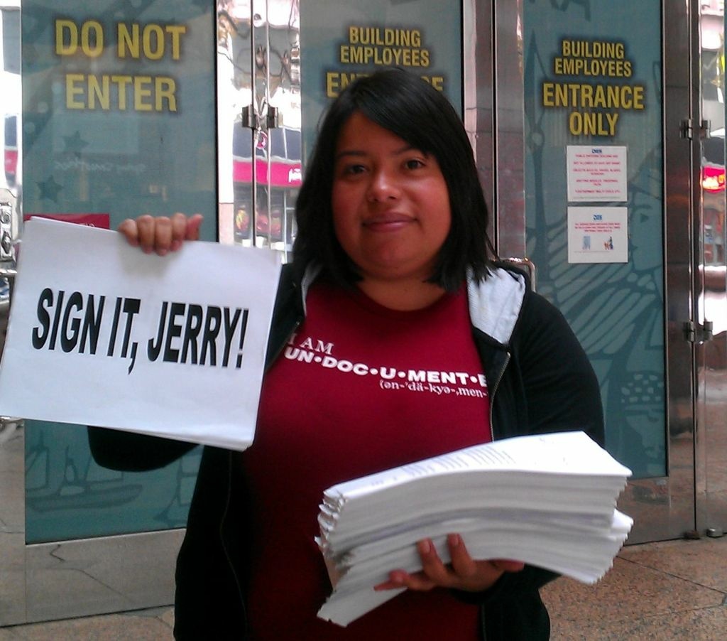 UCLA graduate and California Dream Act supporter Nancy Meza holds petitions in downtown Los Angeles, Wednesday, October 5, 2011