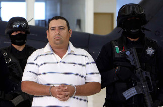 Alleged drug trafficker Jose Antonio Medina, aka 'Don Pepe', is escorted by police officers during a press conference in Mexico City on March 25, 2010. Medina was arrested recently in Michoacan State.