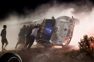 Workers push an overturned off-road race truck upright Sunday after it went out of control and plowed into a crowd of spectators during a race earlier in Lucerne Valley, Calif., Saturday, Aug. 14, 2010. At least eight people were killed during the incident about 100 miles east of Los Angeles.