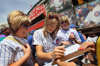 Chicago Cubs fan Jessica Polte signs a petition urging the team to move their spring training camp out of Arizona prior to the Cubs game against the Pittsburgh Pirates at Wrigley Field May 14, 2010 in Chicago, Illinois.