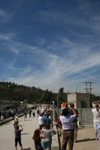 Space Shuttle Endeavour flying over crowds at Devils Gate Dam in Pasadena. 