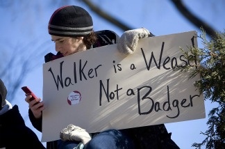 Juliet Lena of Kansasville, Wis., uses her phone to keep track of news as she joins protesters to kill Wisconsin Gov. Scott Walker's bill during a rally at the Capital Building on Feb. 18, 2011 in Madison, Wis.