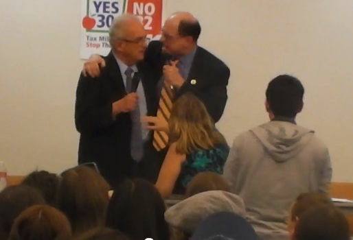 Congressman Brad Sherman swings his arm around Congressman Howard Berman during a debate Thursday night, October 11 in the San Fernando Valley.