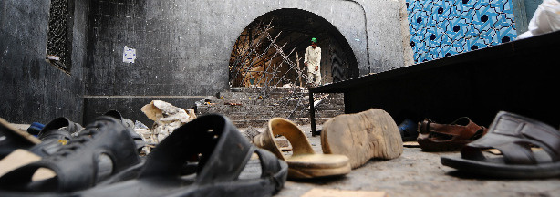 A Pakistani devotee looks at wreckage the day after a suicide bomb attack at a Sufi shrine in Lahore. Two suicide bombers blew themselves up in the Islamic shrine packed with worshippers on July 1, killing at least 37 people and wounding scores more.