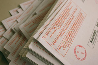 File photo: A stack of vote-by-mail ballots sit on a table prior to being sorted at the San Francisco Department of Elections January 24, 2008 in San Francisco, California.