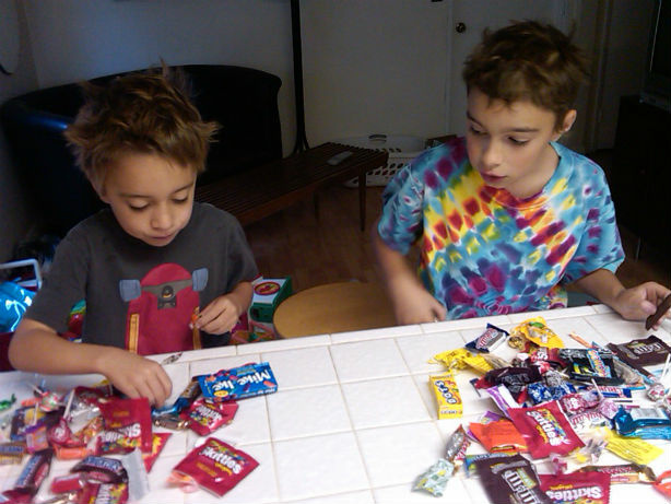 After Halloween, James (left) has discovered the value of a barter economy. Lucia (right) looks on in awe.