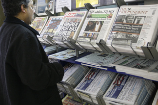 A man views a news stand displaying national newspapers, some carrying the story on WikiLeaks' release of classified U.S. State Department documents, at a newsagent in central London, Monday, Nov. 29, 2010.