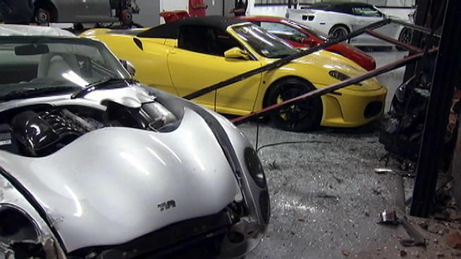 A TVR Tuscan and a yellow Ferrari are seen damaged inside Specialty Craft Car on South La Cienega Boulevard.