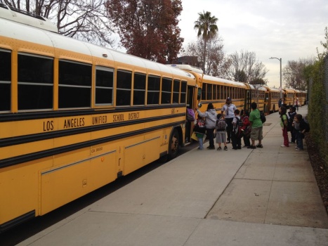 Students bus Loyola Village Elementary School
