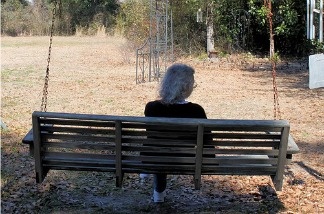 Elderly woman on a swing.