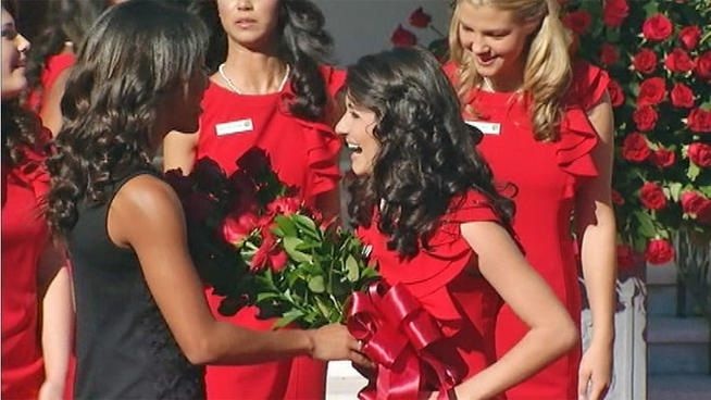 In this screen capture from Tuesday morning's ceremony, 2013 Rose Queen Vanessa Natalie Manjarrez is greeted at the Tuesday announcement ceremony by outgoing 2012 Rose Queen Drew Washington.