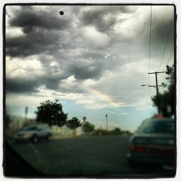 Clouds over Los Angeles delivering rain and a little rainbow