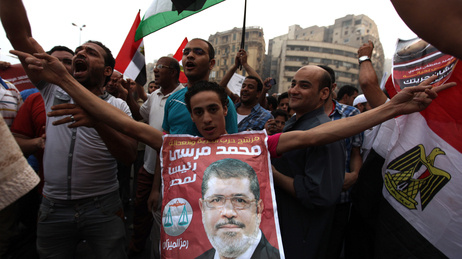 Supporters of Muslim Brotherhood candidate Mohammed Mursi (in portrait) celebrated June 18, 2012 in Cairo's Tahrir Square.