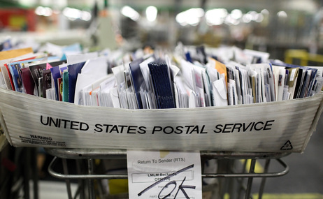 Cartons of mail ready to be sorted sit on a shelf at the U.S. Post Office sort center in San Francisco, California.