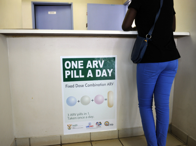A woman waits to get AIDS drugs on April 8 at a clinic in Ga-Rankuwa, South Africa, about 55 miles north of Johannesburg. New WHO guidelines say patients should start HIV treatment much earlier, before they become extremely sick.
