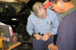 Mike Brown (left), owner of Electro Automotive, works on a gas-to-electric car conversion with a student, Daniel Marcom. Brown has been selling the parts to make such conversions since 1979.