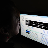 A journalist reads information on the on