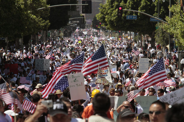 People march along Broadway in downtown Los Angeles during a rally for immigration law reform and to protest against Arizona's controversial new immigration law on Saturday, May 1, 2010.