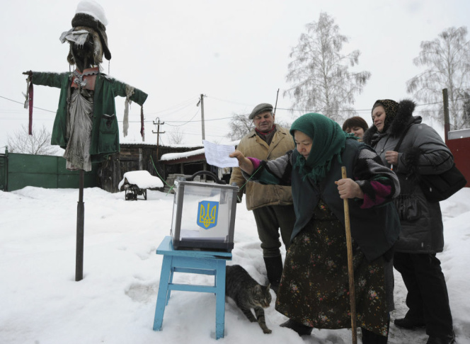An elderly Ukrainian woman places her ba