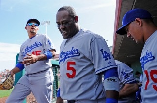 Juan Uribe (#5) and Rafael Furcal (#15) of the Los Angeles Dodgers walk out the dugout against the San Francisco Giants during the sixth inning of a spring training baseball game at Scottsdale Stadium on March 18, 2011, in Scottsdale, Ariz. The two teams face off again on opening day Thursday at Dodger Stadium.