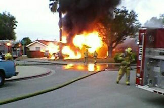Photo of the Tustin fire that destroyed 2 vehicles and damaged a garage.