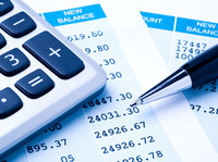 Close-up of a calculator, pen, and financial statement.