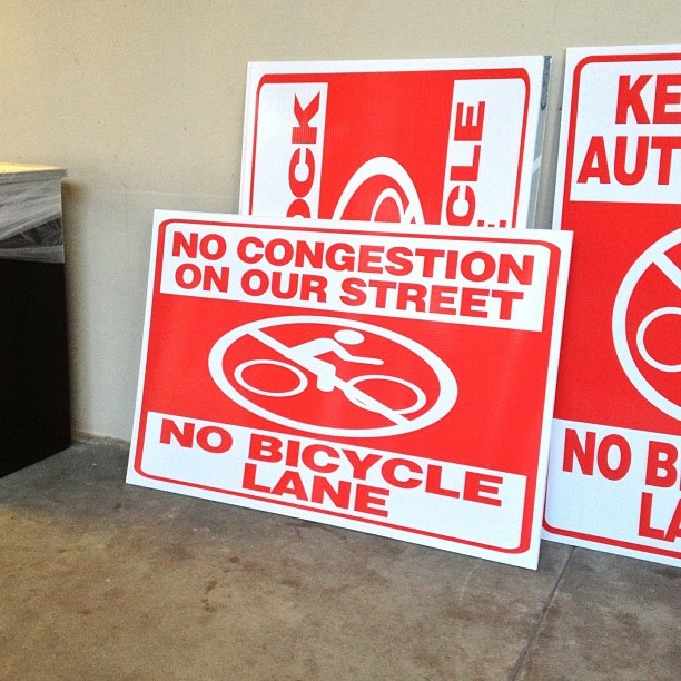 Anti-bike lane signs like these have been popping up on storefront windows in Colorado Boulevard in Eagle Rock.