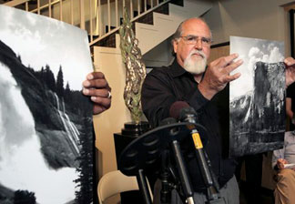 Rick Norsigian holds up a photograph made from a glass negative shot by the late photographer Ansel Adams during a news conference in Beverly Hills, on Tuesday July 27,2010. A lawyer says the trove of old glass negatives found in a garage sale for 45 dollars by Norsigian a painter from Fresno, Calif. has been authenticated as the work of photographer Ansel Adams and are worth at least $200 million.