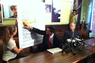 At a Los Angeles news conference, Attorney Garo Mardirossian points to medical records he says indicates Fullerton homeless man Kelly Thomas died of brain injuries caused by head trauma. Seated next to Mardirossian (right) is Thomas' father, Ron Thomas.