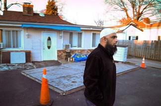 A worshipper who asked not to be identified walks away from the locked Islamic Circle of North America mosque in Alexandria, Va,, Thursday Dec. 10, 2009. The mosque is linked to the five Americans detained in Pakistan and is next door to the home of the detained Umar Farooq.