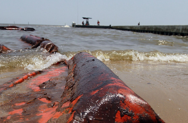 An oil coated containment boom is seen on the beach after it was moved out of place by high winds and waves in the past days which brought oil ashore from the Deepwater Horizon oil spill in the Gulf of Mexico on July 9, 2010 in Waveland, Mississippi.
