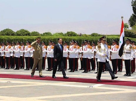 Syrian President Bashar Assad reviews the honor guard upon his arrival at the presidential palace in Damascus to take the oath of office for his third seven-year term.