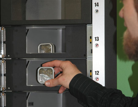 A patient takes his medicine out of the automated medical marijuana machine