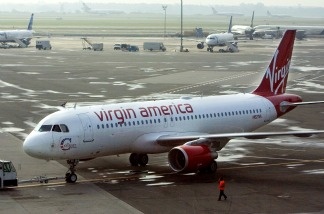 A Virgin America plane waits at JFK International Airport in New York. Olajide Oluwaseun Noibi is charged with stowing away on a Virgin America flight from JFK to LAX on June 25, 2011.