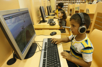 Children play educational video games.