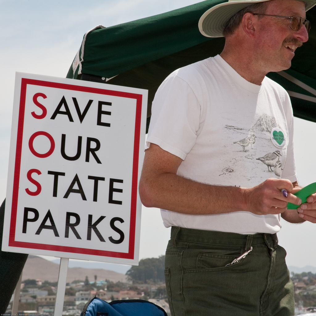 Community members gather signatures in support of state parks during an event on August 28, 2009.