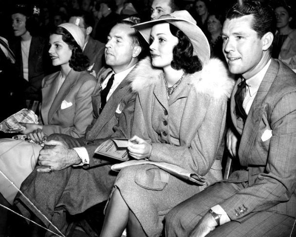 Rita Hayworth, Edward Judson, Doune McKay, and Gordon Oliver watching the Roller Derby at the Pan-Pacific Auditorium.