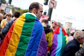 A Prop 8 opponent wears a gay pride flag on his back during a rally to celebrate the ruling to overturn Prop 8 August 4, 2010 in San Francisco.